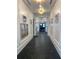 Elegant hallway with dark flooring and framed artwork at 3101 Hollow Hickory Pl, Wesley Chapel, FL 33543