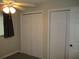 Bedroom featuring neutral walls, carpet, a ceiling fan, and large closets for ample storage at 4469 Keyes Ave, Spring Hill, FL 34606