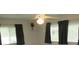 Standard bedroom with a ceiling fan and window with dark curtains for optimal light control at 4469 Keyes Ave, Spring Hill, FL 34606