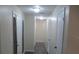 Bright hallway with lighting and neutral walls connecting various rooms in the home at 4469 Keyes Ave, Spring Hill, FL 34606