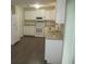 Modern kitchen features white appliances, granite countertops, and plenty of cabinet space at 4469 Keyes Ave, Spring Hill, FL 34606