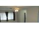 Bright and airy living room with a ceiling fan and large windows and dark curtains at 4469 Keyes Ave, Spring Hill, FL 34606