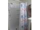 Bright shower featuring built-in shelving and a stylish shower curtain for a refreshing and organized space at 4469 Keyes Ave, Spring Hill, FL 34606