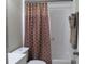 Clean bathroom with shower/tub combo and patterned shower curtain at 4469 Keyes Ave, Spring Hill, FL 34606