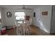 Dining room with round table, white chairs, and wood flooring at 7316 Tropical Dr, Weeki Wachee, FL 34607