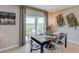 Bright dining room features a rustic farmhouse table with white chairs, and sliding glass doors leading to the backyard at 7639 Rome Ln, Brooksville, FL 34613