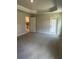 Spacious bedroom with tray ceiling, carpeted floors, neutral paint and walk-in closet at 12283 Ipswich Sparrow Rd, Weeki Wachee, FL 34614