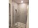 Modern bathroom featuring a walk-in glass shower with grey tile walls and recessed niche at 324 Galaxy Ave, Spring Hill, FL 34606