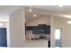 Modern kitchen featuring stainless steel appliances, granite countertops, and dark cabinetry at 324 Galaxy Ave, Spring Hill, FL 34606