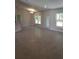 Open-concept living room with tile flooring, recessed lighting, and natural light from large windows at 324 Galaxy Ave, Spring Hill, FL 34606