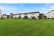 Back of the building with a large grassy yard at 4901 Onyx Ln # 101, New Port Richey, FL 34652