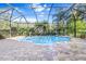 Screened pool and patio with a tranquil view of the surrounding landscape at 19617 Sunset Bay Dr, Land O Lakes, FL 34638
