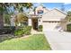 Two-story house with attached garage and manicured lawn at 19617 Sunset Bay Dr, Land O Lakes, FL 34638
