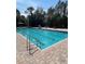 Community pool with ample deck space at 19617 Sunset Bay Dr, Land O Lakes, FL 34638