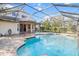Relaxing pool and patio area with screened enclosure and home view at 19617 Sunset Bay Dr, Land O Lakes, FL 34638