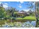 House exterior with a screened patio and lake view at 19617 Sunset Bay Dr, Land O Lakes, FL 34638