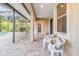 Covered patio with seating area adjacent to the pool at 19617 Sunset Bay Dr, Land O Lakes, FL 34638