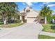 Two-story house with attached garage and manicured lawn at 19617 Sunset Bay Dr, Land O Lakes, FL 34638