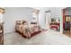 Bright bedroom with a floral bedspread and en-suite bathroom access at 19617 Sunset Bay Dr, Land O Lakes, FL 34638