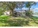 Pool and patio area with lush landscaping and pond view at 19617 Sunset Bay Dr, Land O Lakes, FL 34638