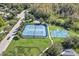 Tennis and basketball courts with surrounding green space at 19617 Sunset Bay Dr, Land O Lakes, FL 34638