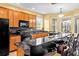 Modern kitchen with wood cabinets, granite counters, and black appliances at 19617 Sunset Bay Dr, Land O Lakes, FL 34638