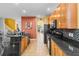 Modern kitchen with wood cabinets, granite counters, and breakfast bar at 19617 Sunset Bay Dr, Land O Lakes, FL 34638