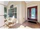 Front porch with brick flooring and two chairs at 19617 Sunset Bay Dr, Land O Lakes, FL 34638
