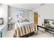 Charming bedroom with striped bedding and TV at 19617 Sunset Bay Dr, Land O Lakes, FL 34638