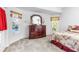 Bedroom with a large dresser, pool view, and window at 19617 Sunset Bay Dr, Land O Lakes, FL 34638