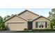 Tan one-story house with two-car garage at 8213 County Line Rd, Spring Hill, FL 34606