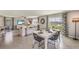 Open concept dining room with white table and black chairs near living room at 30979 Wild Juniper Ct, Brooksville, FL 34602