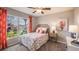 Charming bedroom with floral bedding and large window at 7647 Rome Ln, Brooksville, FL 34613