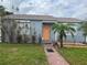 Single story home with orange door and brick walkway at 431 80Th Way, St Pete Beach, FL 33706