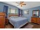 Primary bedroom with wood furniture and ceiling fan at 14713 Wake Robin Dr, Brooksville, FL 34604