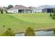 Spacious backyard with large lawn and pond view at 13744 Carryback Dr, Dade City, FL 33525