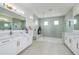 Spa-like Primary bathroom with double vanity, large walk-in shower, and elegant fixtures at 13744 Carryback Dr, Dade City, FL 33525