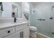 Modern bathroom with white vanity, black accents, and a glass shower at 13744 Carryback Dr, Dade City, FL 33525