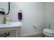 Small powder room with pedestal sink and toilet at 13744 Carryback Dr, Dade City, FL 33525
