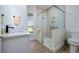 Guest bathroom with walk-in shower, toilet, and single vanity at 13744 Carryback Dr, Dade City, FL 33525