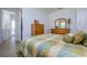 Comfortable guest bedroom with wood furniture and en-suite bathroom at 13744 Carryback Dr, Dade City, FL 33525