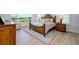 Main bedroom with wood bed frame and access to a private bathroom at 13744 Carryback Dr, Dade City, FL 33525