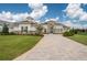 Luxury home with stone accents, tile roof, and paver driveway at 13744 Carryback Dr, Dade City, FL 33525