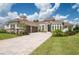 Luxury home with stone accents, tile roof, and paver driveway at 13744 Carryback Dr, Dade City, FL 33525