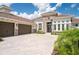Luxury home with three-car garage and paver driveway at 13744 Carryback Dr, Dade City, FL 33525
