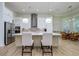 Modern kitchen with large island, stainless steel appliances, and white cabinets at 13744 Carryback Dr, Dade City, FL 33525