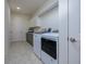 Bright laundry room with washer, dryer, and ample storage at 13744 Carryback Dr, Dade City, FL 33525
