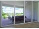 View of backyard patio with seating area and serene lake view at 13744 Carryback Dr, Dade City, FL 33525