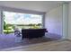 View of backyard patio with seating area and serene lake view at 13744 Carryback Dr, Dade City, FL 33525