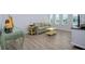 Cozy sitting area with striped sofa, wood floors and wicker accent table at 13744 Carryback Dr, Dade City, FL 33525